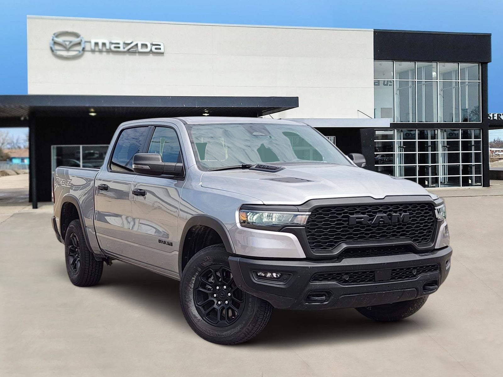 2025 RAM 1500 Rebel in Billet Silver Metallic Clearcoat — front three-quarter view