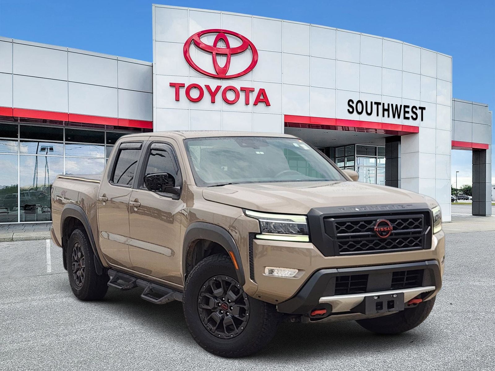 2023 Nissan Frontier PRO-4X in Baja Storm — front three-quarter view