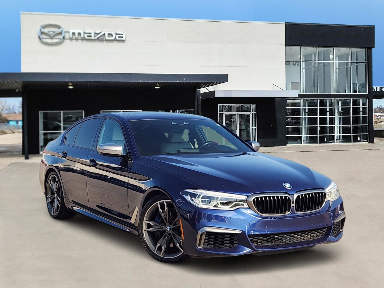 2019 BMW 5 Series M550i xDrive in Mediterranean Blue Metallic — front three-quarter view